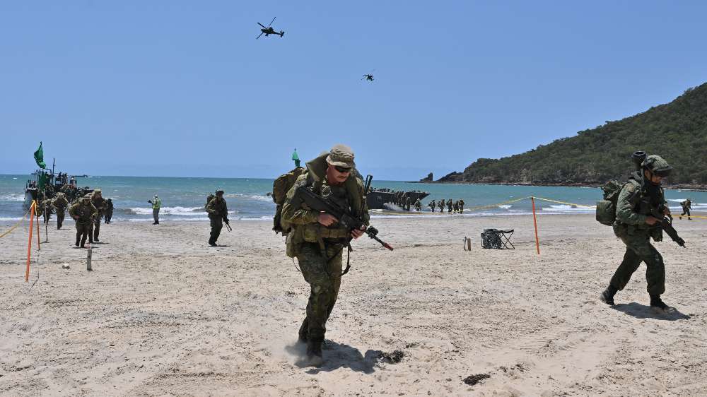 3rd Battalion, Singapore Guards (3 Gds) and Australian Defence Force troops disembark from the Republic of Singapore Navy’s Fast Craft Utility, with the Republic of Singapore Air Force Apaches providing close air support, during Exercise Trident 2024.